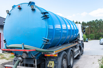 A truck with a large tank for pumping out a septic tank with a capacity of more than 20 cubic...
