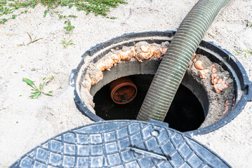 A four-inch suction pipe inserted into a home septic tank, suction of household wastewater.