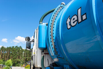 A truck with a large tank for pumping out a septic tank with a capacity of more than 20 cubic...