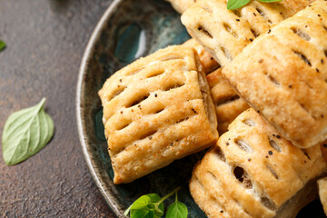 Mini beef patties with vegetables and red wine wrapped in puff pastry