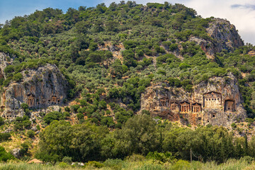 Fototapeta na wymiar Lycian tombs of the city of the dead, carved into the rocks on the Anatolian coast of Turkey near the city of Fathiye