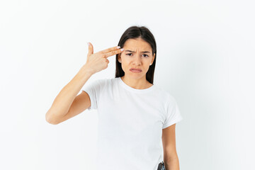 Portrait of sad frustrated woman pointing finger gun to head