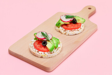 Rice Cake Sandwiches with Avocado, Tomato, Cottage Cheese, Olives and Radish on Wooden Cutting Board. Easy Breakfast. Diet Food. Quick and Healthy Sandwiches. Crispbread with Tasty Filling