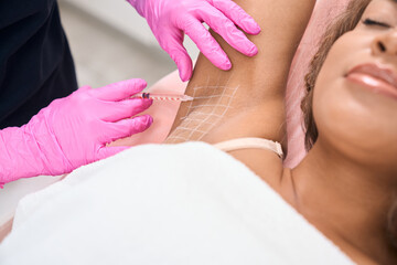 Young patient receives injections in the armpit area