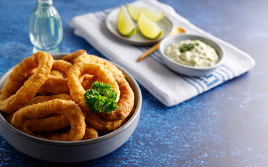 Homemade calamari with tartar sauce. Fresh homemade calamari with homemade tartar sauce and lemon.
