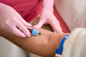 Female hands nurse take blood test from man vein