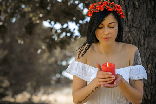 Woman with Candle at nature. Magical attribute, witchcraft concept, fire, Spells and other rite