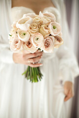 Bright wedding bouquet in hands of the bride
