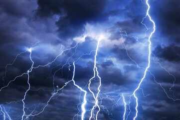 Fork lightning striking down during summer storm - 520347169
