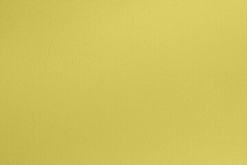 Saturated light pastel greenish yellow colored low contrast Concrete textured background. Empty colourful wall texture with copy space for text overlay and mockups. 2023, 2024 color trend