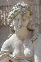 Old sculpture of a sensual woman nymph bathing at the fountain in Zwinger gardens at historical and museums downtown of Dresden, Germany.