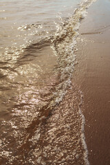 Small waves on a beach closeup