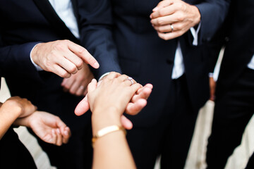 Bride showing engagement ring to wedding guests