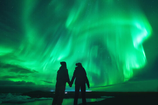 Northern lights over couple in love in Iceland