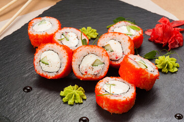 sushi rolls with crab, cucumber and cream cheese in tobiko caviar