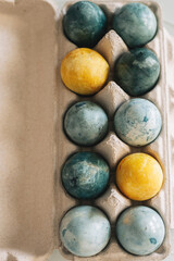 Marble Yellow and Grey Easter Eggs in Stand. Happy Easter. Vertical photo.
