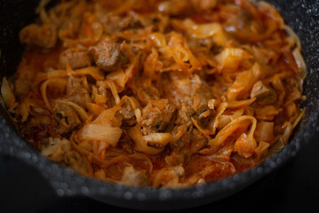 Stewed cabbage in a frying pan. Cooking recipe.