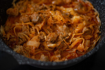 Stewed cabbage in a frying pan. Cooking recipe.