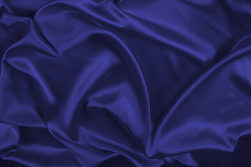 Red silk or satin luxury fabric texture can use as abstract background. Top view.