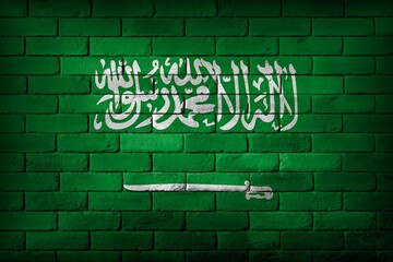 Saudi Arabia flag painted on a brick wall. - obrazy, fototapety, plakaty