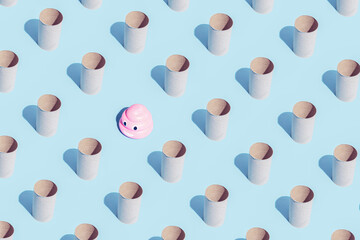 Fototapeta na wymiar Pattern made of Toilet paper rolls and pink poop emoticon on blue. Isometric. High unexpected demand. Seamless pattern. Break the pattern concept.