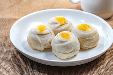 Chinese Pastry,Bean cake with salted egg yolk, 
on a white plate