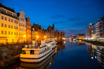 Obraz premium Scenic summer evening panorama of the architectural embankment pier canal river illumination of the Old Town GDANSK, POLAND
