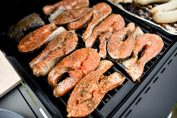 Selective focus on raw salmon steaks on grill