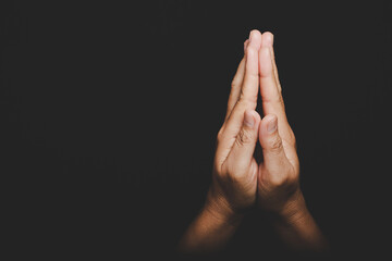 Close up Asian christian woman hands person pray and worship for thank god in church with black...