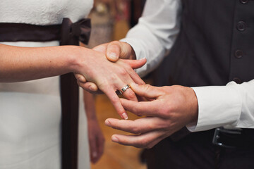 Bride and groom exchange rings at the wedding ceremony