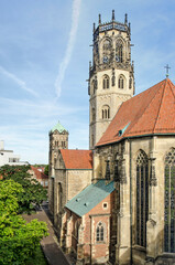Münster, Germany, July 28, 2022: south facade and tower of the Sankt Ludgeri church and adjacent Marienplatz