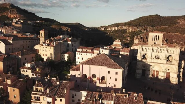 drone shot of a historical town on top of a hill surrounded by trees
