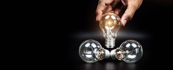 Close up hand choose light bulb or lamp for human resources or leadership and creativity thinking idea motivation or vision and knowledge learning and study or education concept.