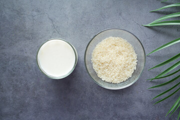 Fototapeta na wymiar glass of milk and rice on a table, non dairy milk concept 