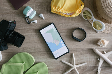 top view travel concept with retro camera films, smartphone, map, passport, compass and Outfit of traveler, Tourist essentials.