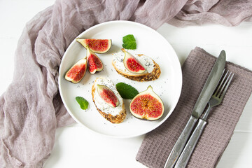 Healthy sandwiches with fresh figs and cream cheese, mint leaves, white  plate, white background, healthy eating, healthy sandviches