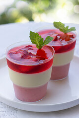 Strawberry mousse , summer dessert, beautiful cakes, vegan sweets, portion cups in delivery box. Strawberry jelly