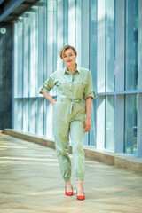 Blonde woman in a green jumpsuit