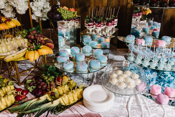 Candy bar. Sweet table in pink and blue colors. Delicious sweet buffet with cupcakes. Holiday...