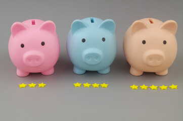 Financial funds and banks ranking. Piggy banks with different amount of stars close up.