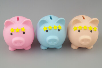 Rating of financial organizations. Three piggy banks with different numbers of stars on gray background.
