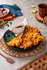 Bakwan is a vegetable fritter or gorengan from Indonesian cuisine.The ingredients are vegetables, usually beansprouts, shredded cabbages and carrots, battered and deep fried in cooking oil.