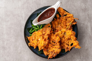 Bakwan is a vegetable fritter or gorengan from Indonesian cuisine.The ingredients are vegetables, usually beansprouts, shredded cabbages and carrots, battered and deep fried in cooking oil.