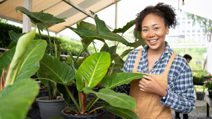 Portrait of beautiful women owner standing in own tree shop and smiling. African American females business partners working garden store. Business concept.Tablet quality control.Clip board.