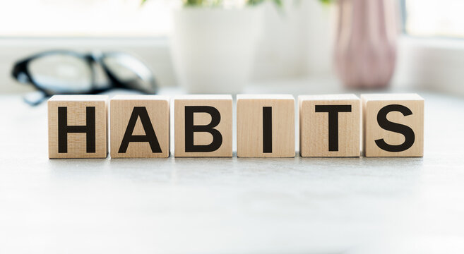 HABITS word written on wood block. HABITS text on cement table for your design, concept
