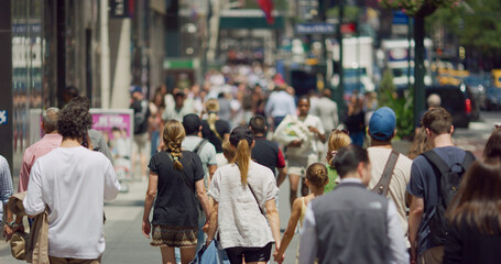 Anonymous crowd of people walking street
