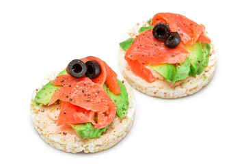 Rice Cake Sandwiches with Fresh Salmon, Avocado and Olives - Isolated on White. Easy Breakfast. Diet Food. Quick and Healthy Sandwiches. Crispbread with Tasty Filling. Healthy Dietary Snack -