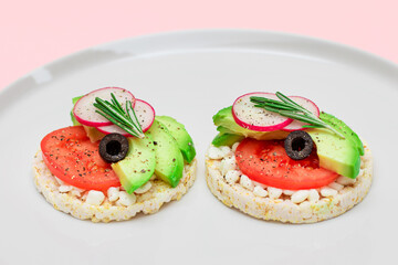 Rice Cake Sandwich with Avocado, Tomato, Cottage Cheese, Olives and Radish on White Plate. Easy Breakfast. Diet Food. Quick and Healthy Sandwiches. Crispbread with Tasty Filling. Healthy Dietary Snack