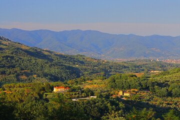 Naklejka premium Landscape View from Montecatini Alto looking towards Pistoia with the Apennine Mountains in the distance. Tuscany, Italy.