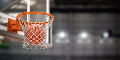Basketball ball scoring the winning  points on basketball net hoop on basketball arena. - obrazy, fototapety, plakaty